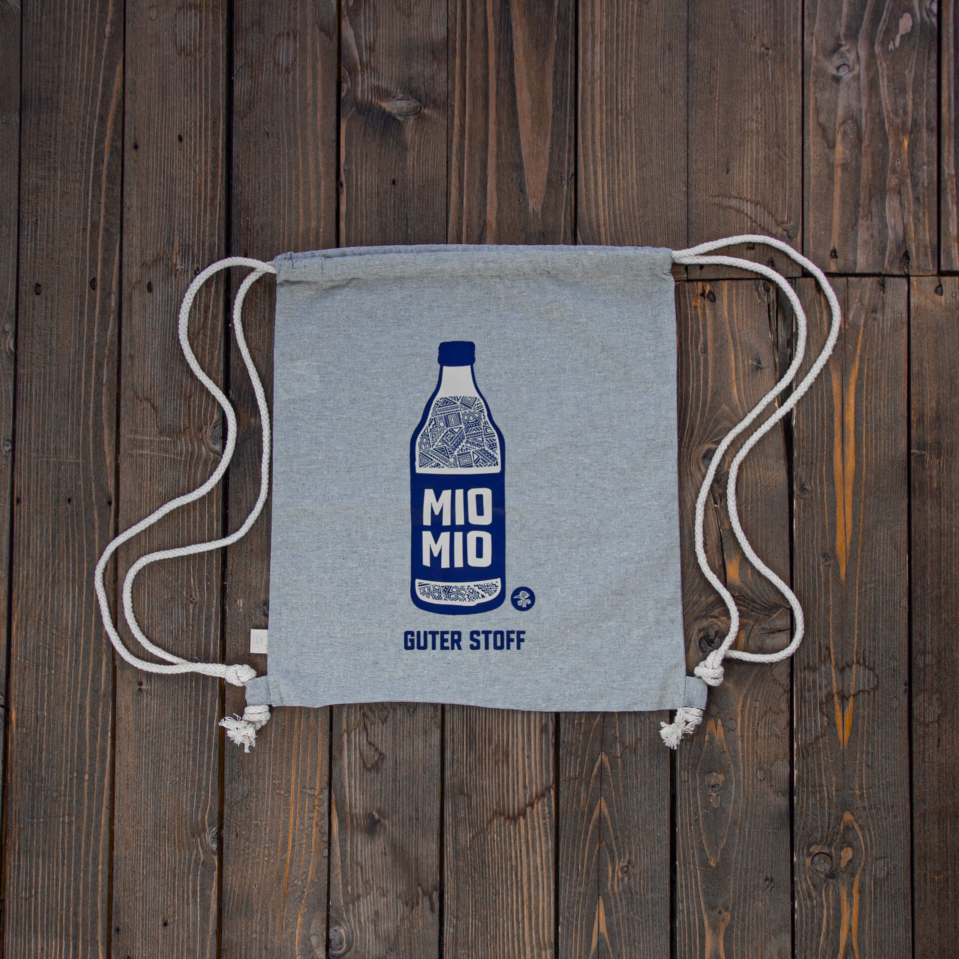 Grauer Baumwollbeutel mit blauem Mio Mio Flaschendruck